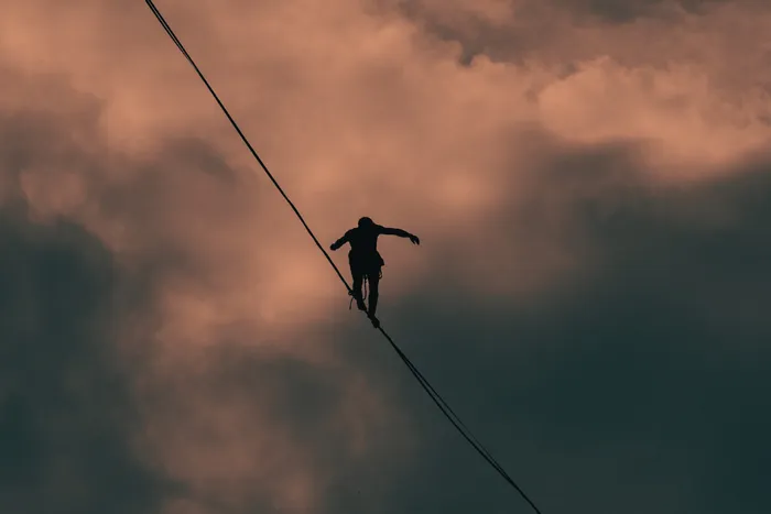 A person balancing on a thin rope.